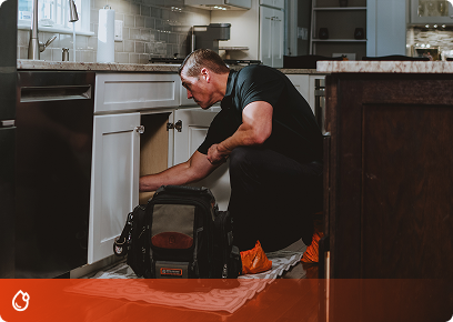 Precision-Plumbing-CTA Precision Today plumber working on pipes under a kitchen sink