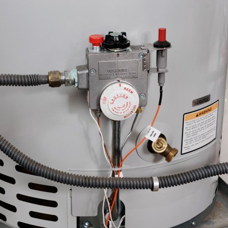 a hose attached to drain water heater at a home
