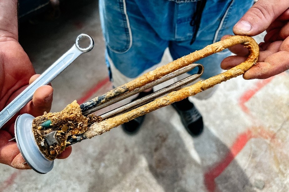 Corroded water heater component in the hands of a Chicagoland resident.