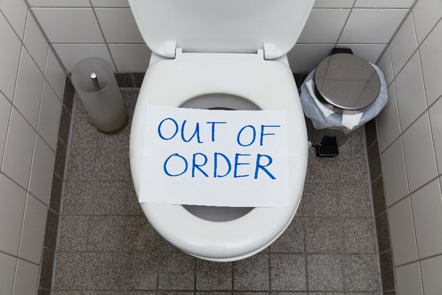 An “Out of Order” sign placed over a toilet in Chicagoland.