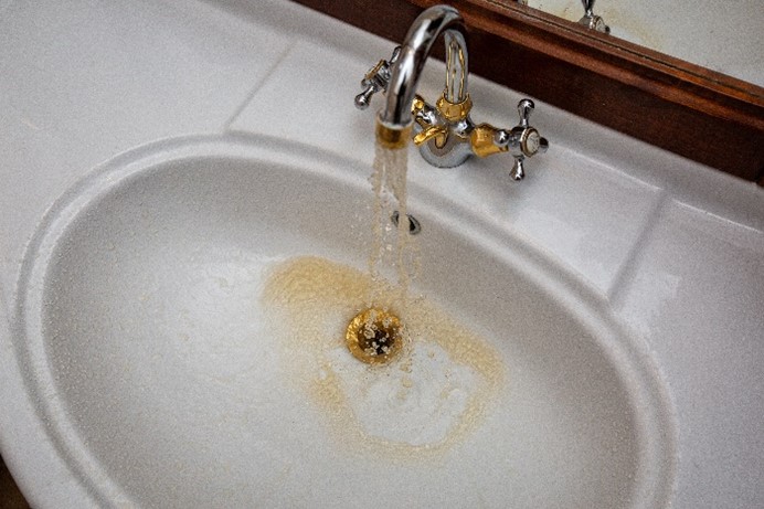 Rusty and discolored water coming from the sink’s faucet in a home in Carol Stream, IL.