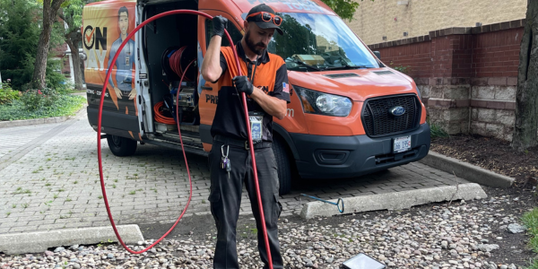 Drain technician showing work to clear a sewer line