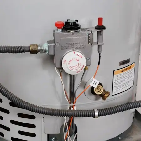 a hose attached to drain water heater at a home